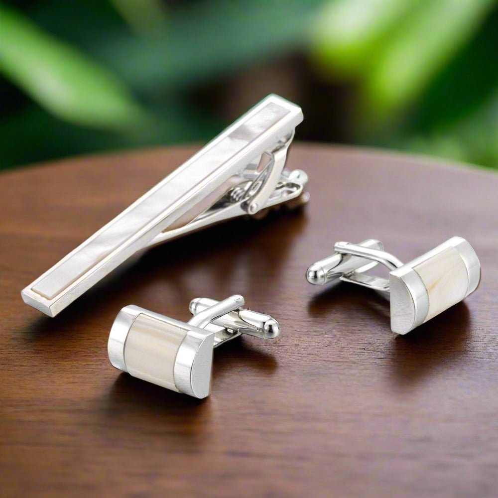 Close-up of luxury men's tie bar and cufflinks with mother of pearl detail