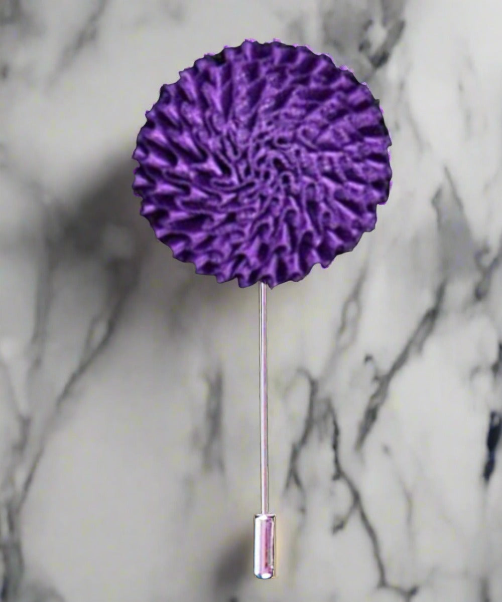 Vibrant burst fabric lapel pin with colorful floral design on a blazer