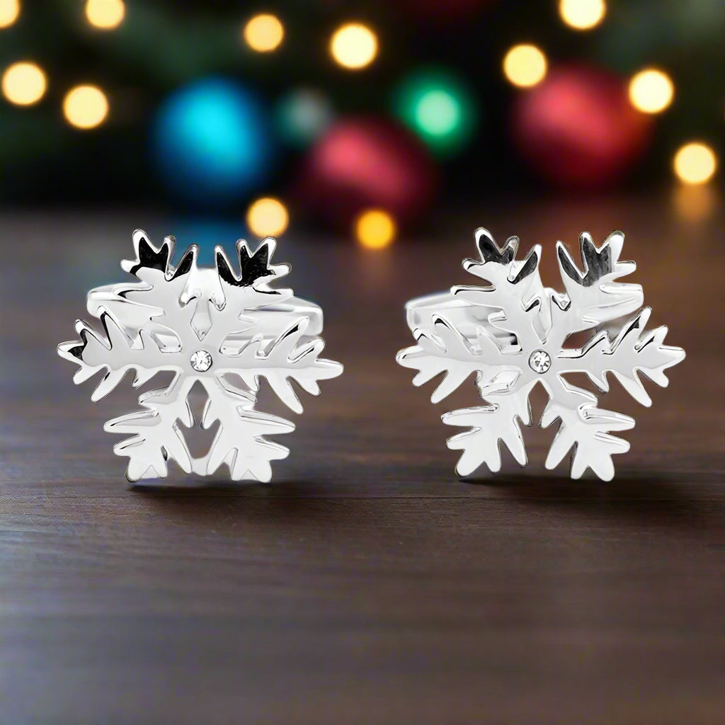 Chrome snowflake cufflinks with intricate winter design on a white background